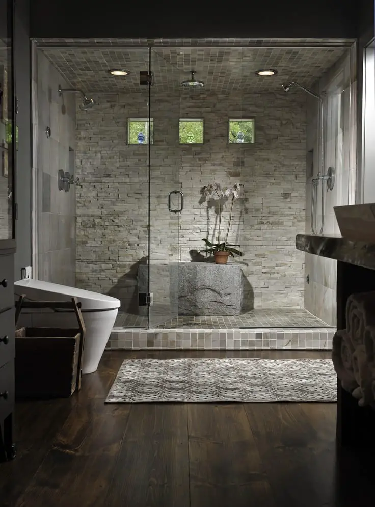 Beautiful natural looking shower stall with stone seat